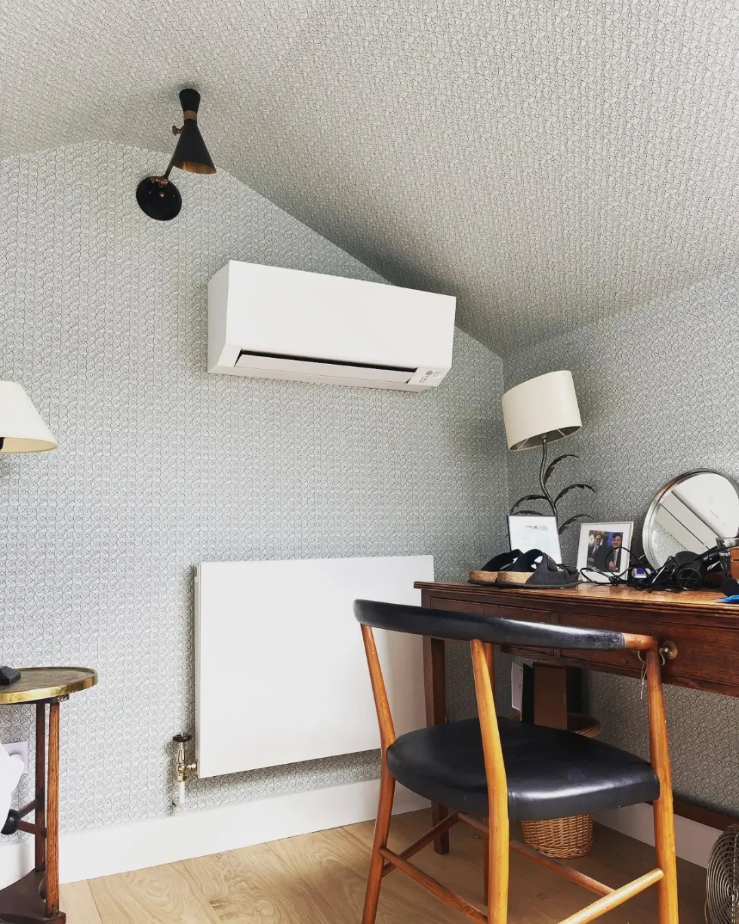 Air conditioning unit fitted in a home office under a sloped ceiling